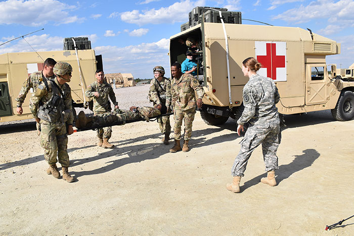 U.S. Army medics cary Soldier