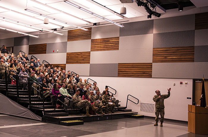 BG Anthony L. McQueen speaks with team members