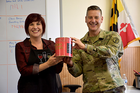 Col. Ryan Bailey, USAMMDA commander, presents Christina Benson with trophy