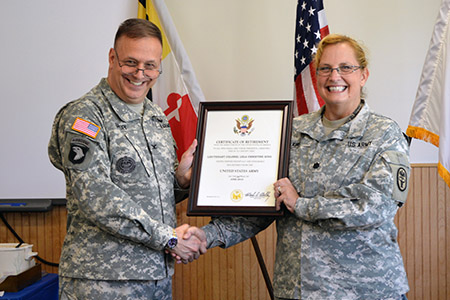 Col. William Geesey presents certificate of retirement to Lt. Col. Lela King