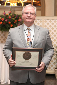 Scott Doughty poses with Bronze Medal Federal Executive Board Award at Baltimore Luncheon May 6.