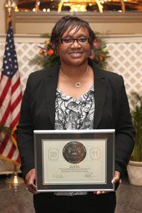 Tara Mose poses with Silver Medal Federal Executive Board Award at Baltimore Luncheon May 6.