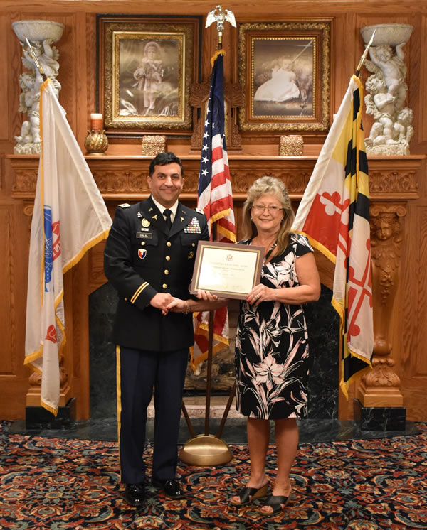 Col. Stephen Delal presents Cindy Cutsail with a Certificate of Retirement