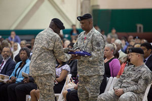Col. Isiah Harper is presented with the U.S. Flag